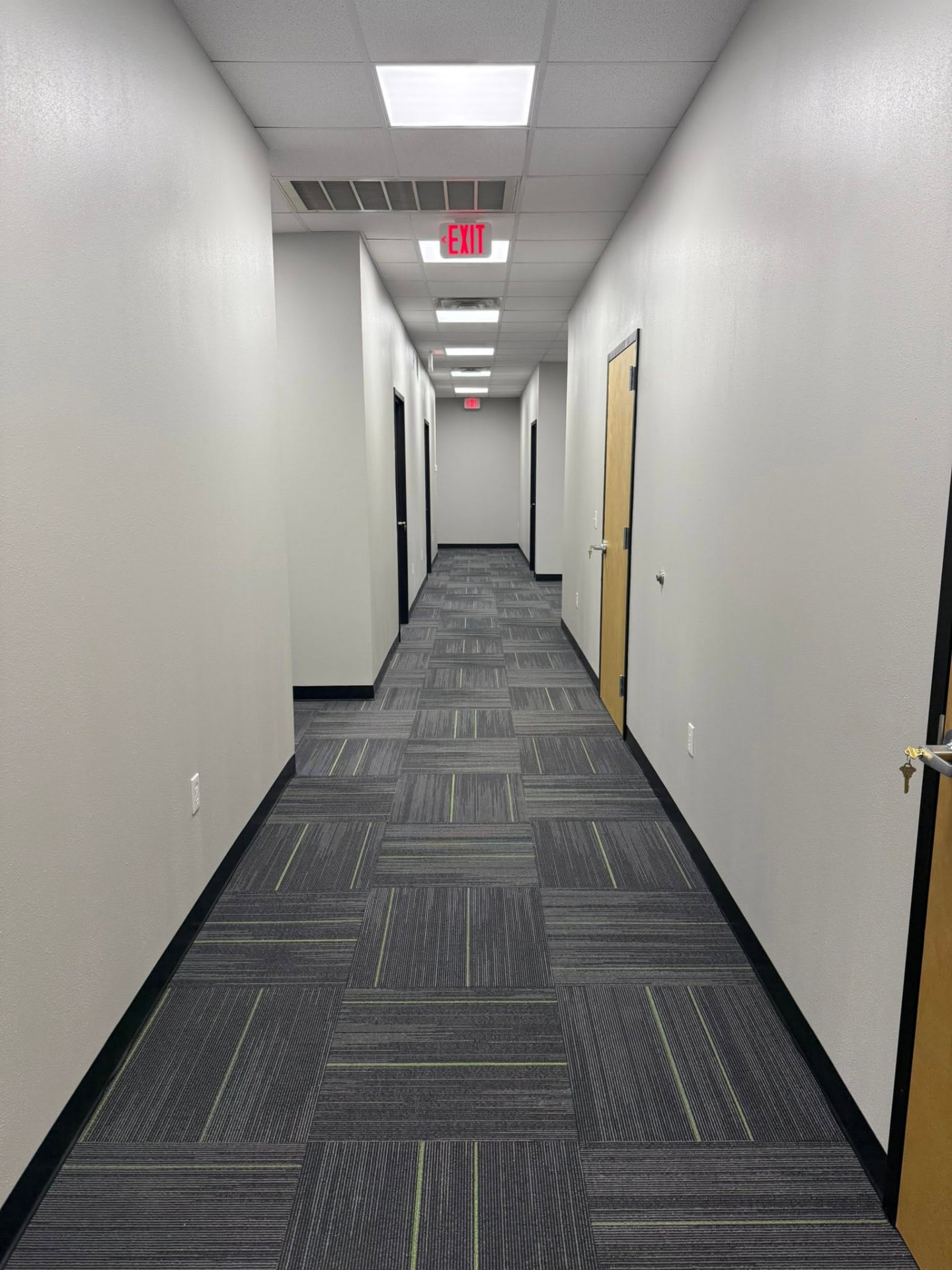 Audibel Jones Creek completed corridor with carpet tile and finished ceilings