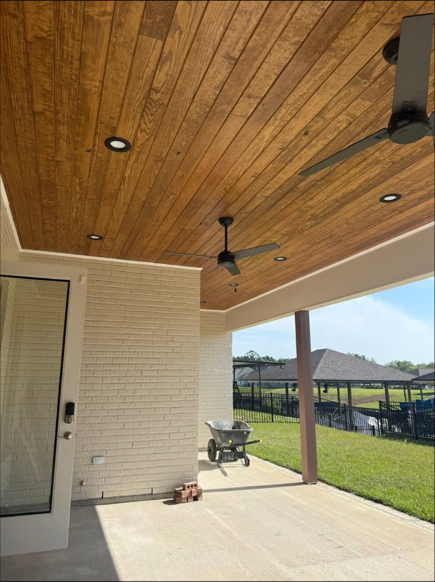 Yellow Fin Springfield covered patio with stained wood ceiling and fans
