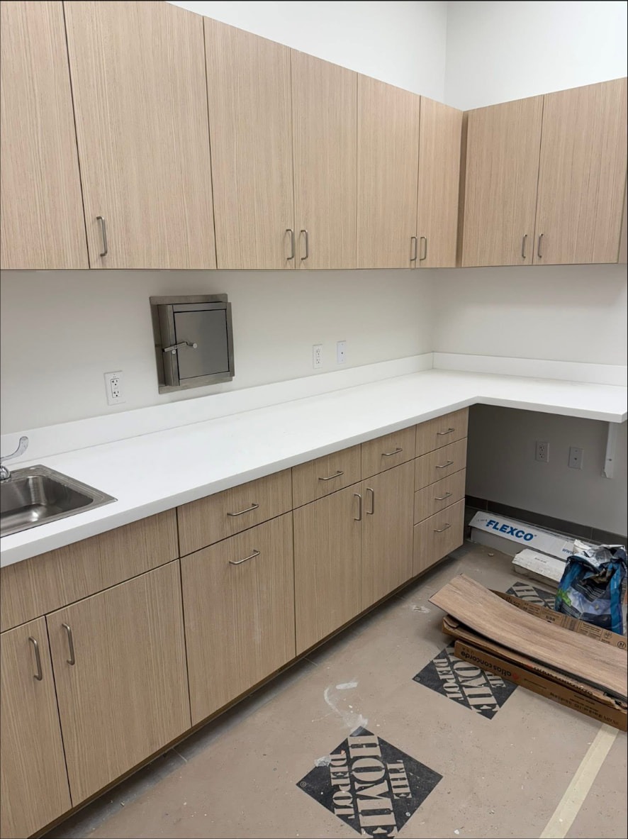 Finished lab casework with solid-surface counter and stainless pass-through