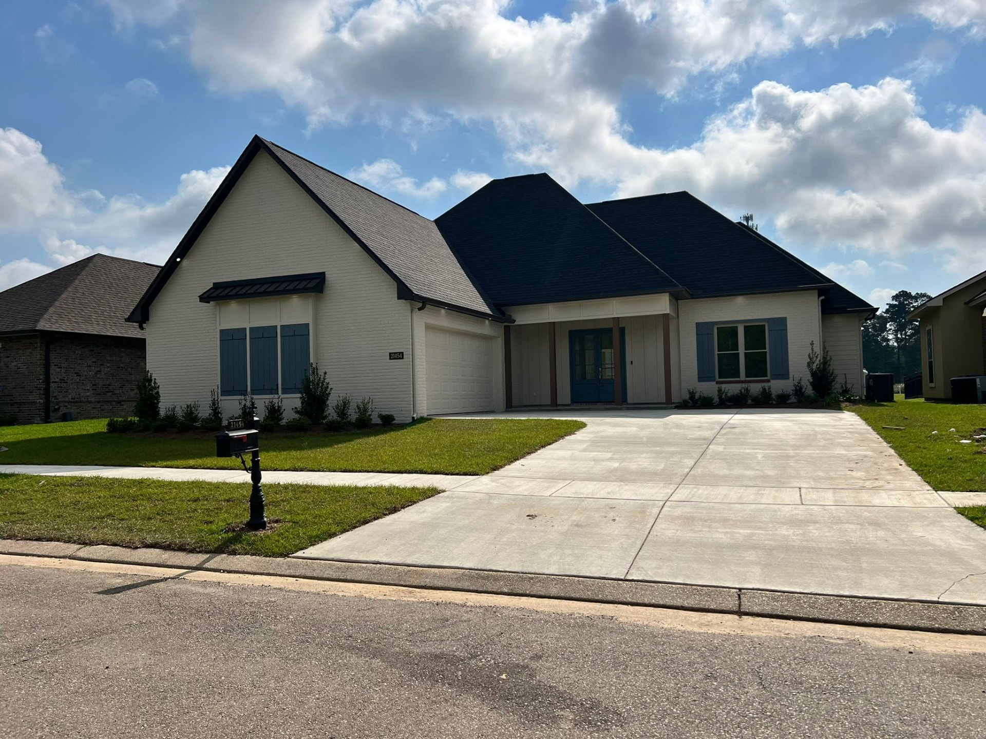 Yellow Fin house completed — finished exterior with driveway and landscaping