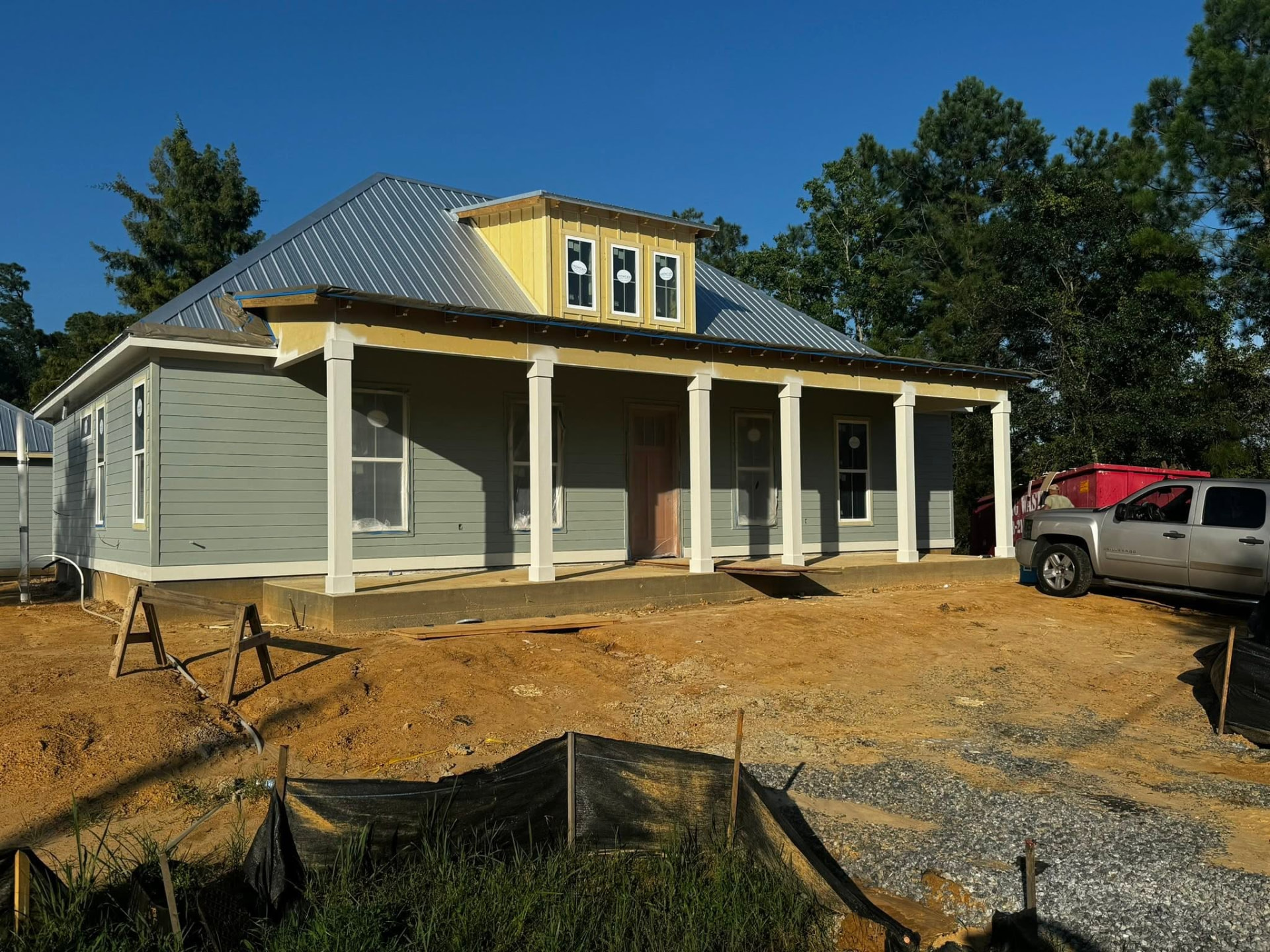 Completed Waveland home exterior with standing seam metal roof and front porch