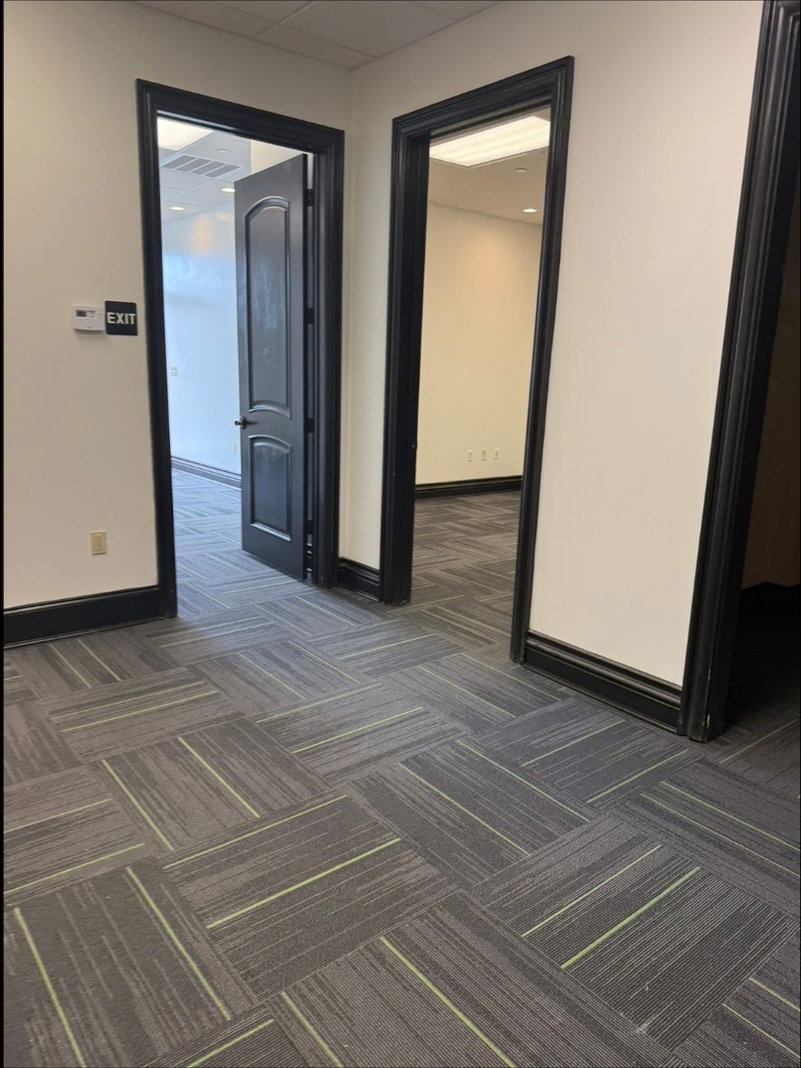 Finished corridor with black door frames and carpet tile at the Audibel clinic in Gretna